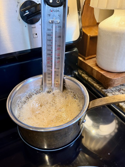 Homemade honey cough drop syrup boiling in saucepan