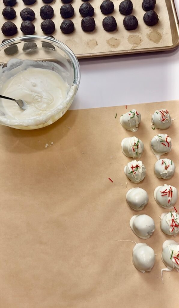 Dipping oreo balls into white chocolate