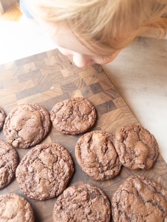 Little boy smelling chocolate chunk cookies