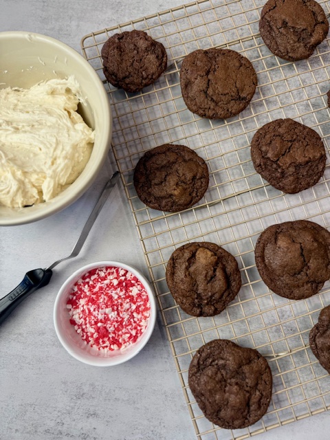 Chocolate cookies on wire rack ready to frost.