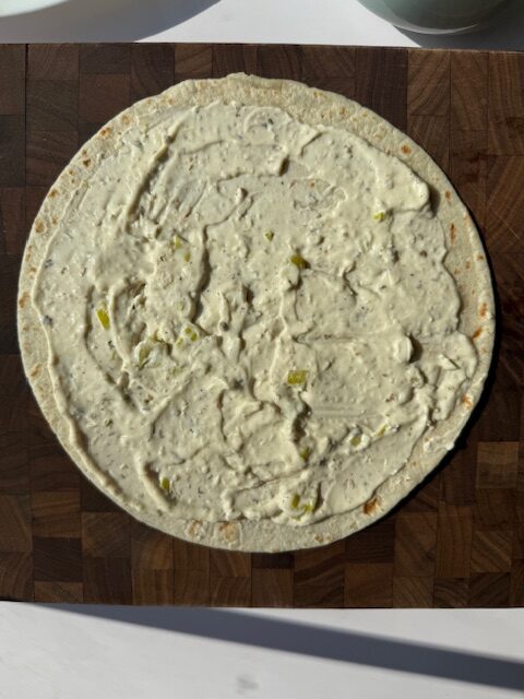 Cream cheese spread on tortilla