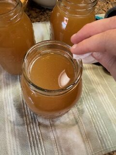 Wiping Mason jars with clean cloth