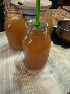 Placing Hot lids on jars of broth