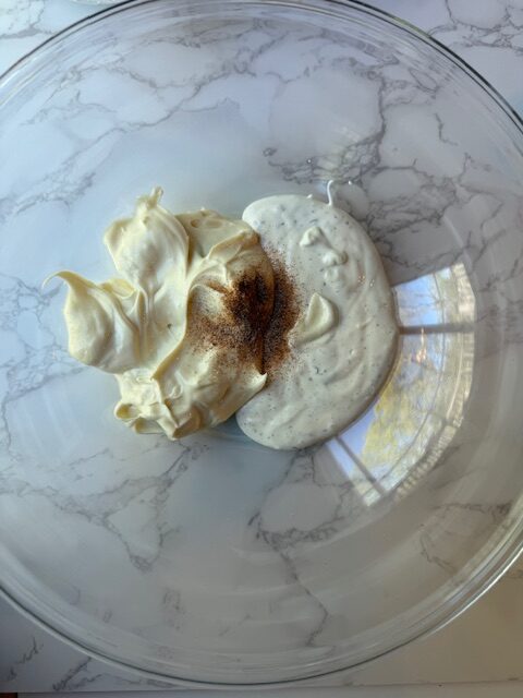 Mayo Ranch and season salt in clear mixing bowl