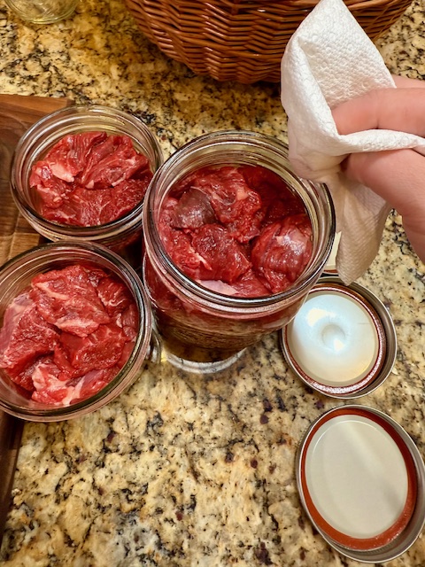 Wiping rims of jars with vinegar