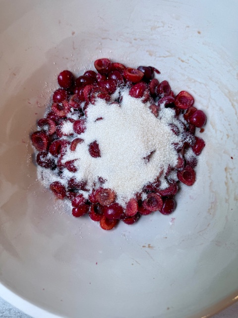Sugar and cherries in mixing bowl