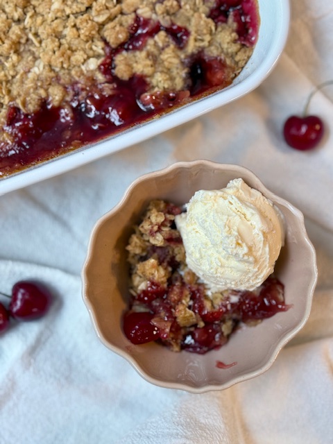 Cherry Crisp in small bowl with ice cream on top