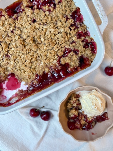 Cherry Crisp in small bowl with ice cream on top