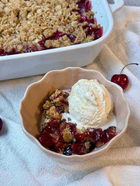 Cherry Crisp in small bowl with ice cream on top
