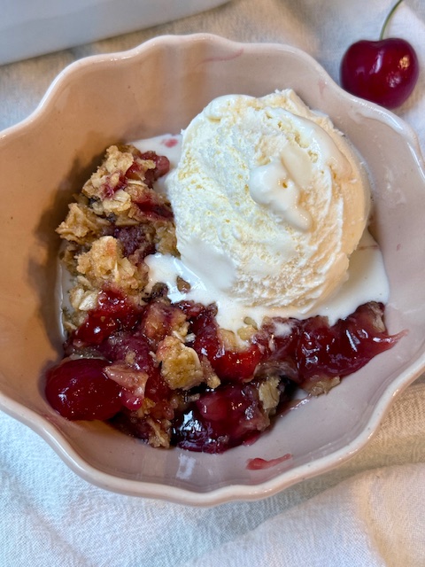Cherry Crisp in small bowl with ice cream on top