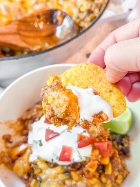 Tortilla Chip scooping Mexican Beef and Rice Skillet