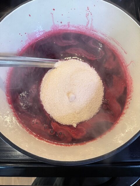 Blackberry juice and sugar in dutch oven