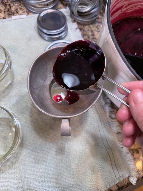 Pouring blackberry jelly into jars