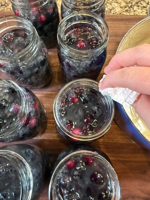 wiping rims of mason jars