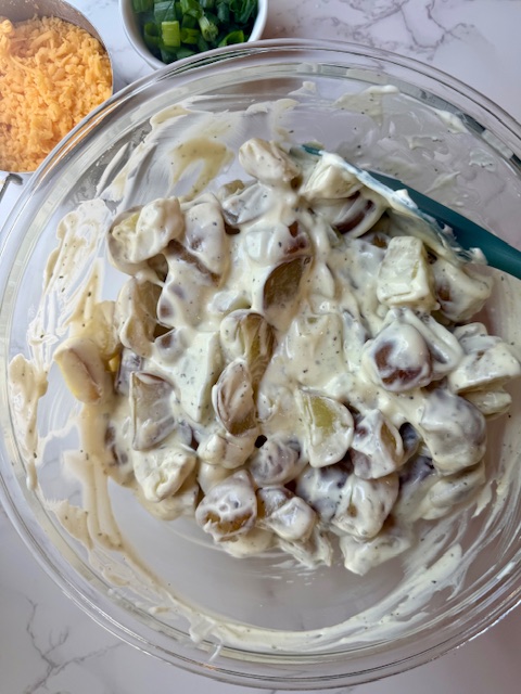 Stirring potatoes with dressing mixture