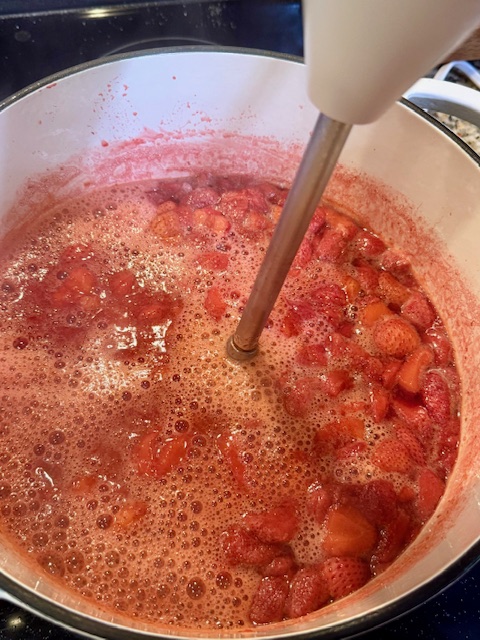 pureeing strawberries with emersion blender
