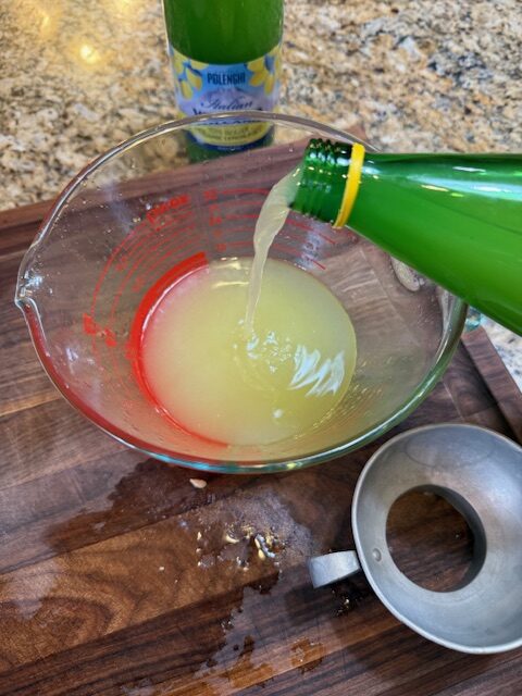 pouring lemon concentrate into measuring cup