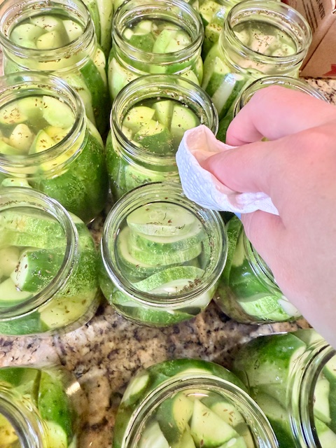 wiping jars clean with paper towel